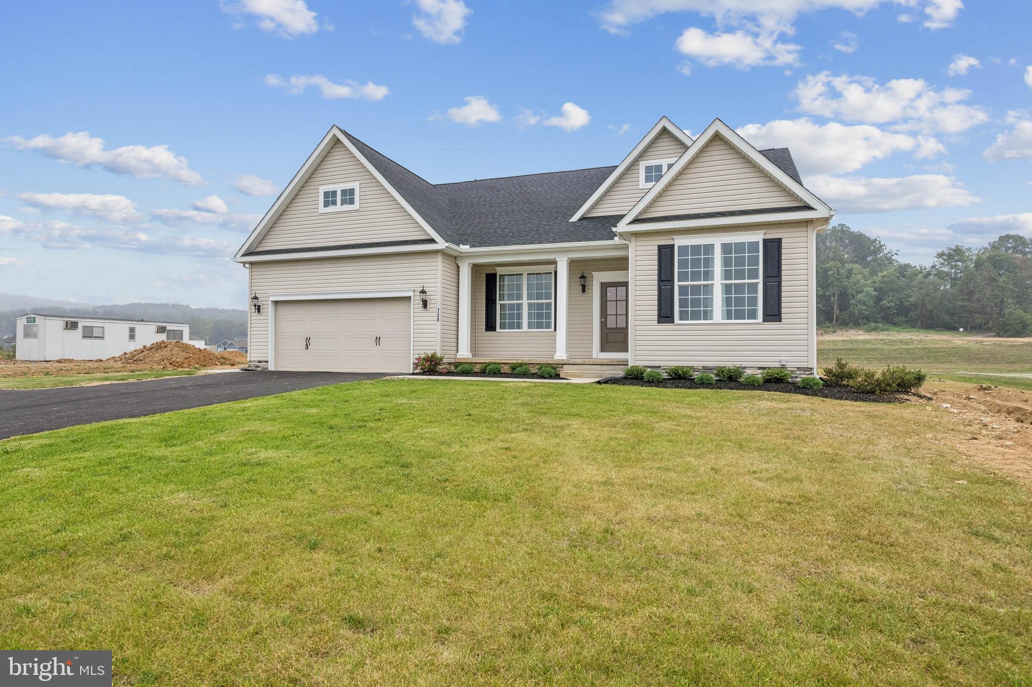 136 Piedmont Way, Unit 102 Hanover, PA 17331 - Photo 2 of 40 a front view of a house with a garden