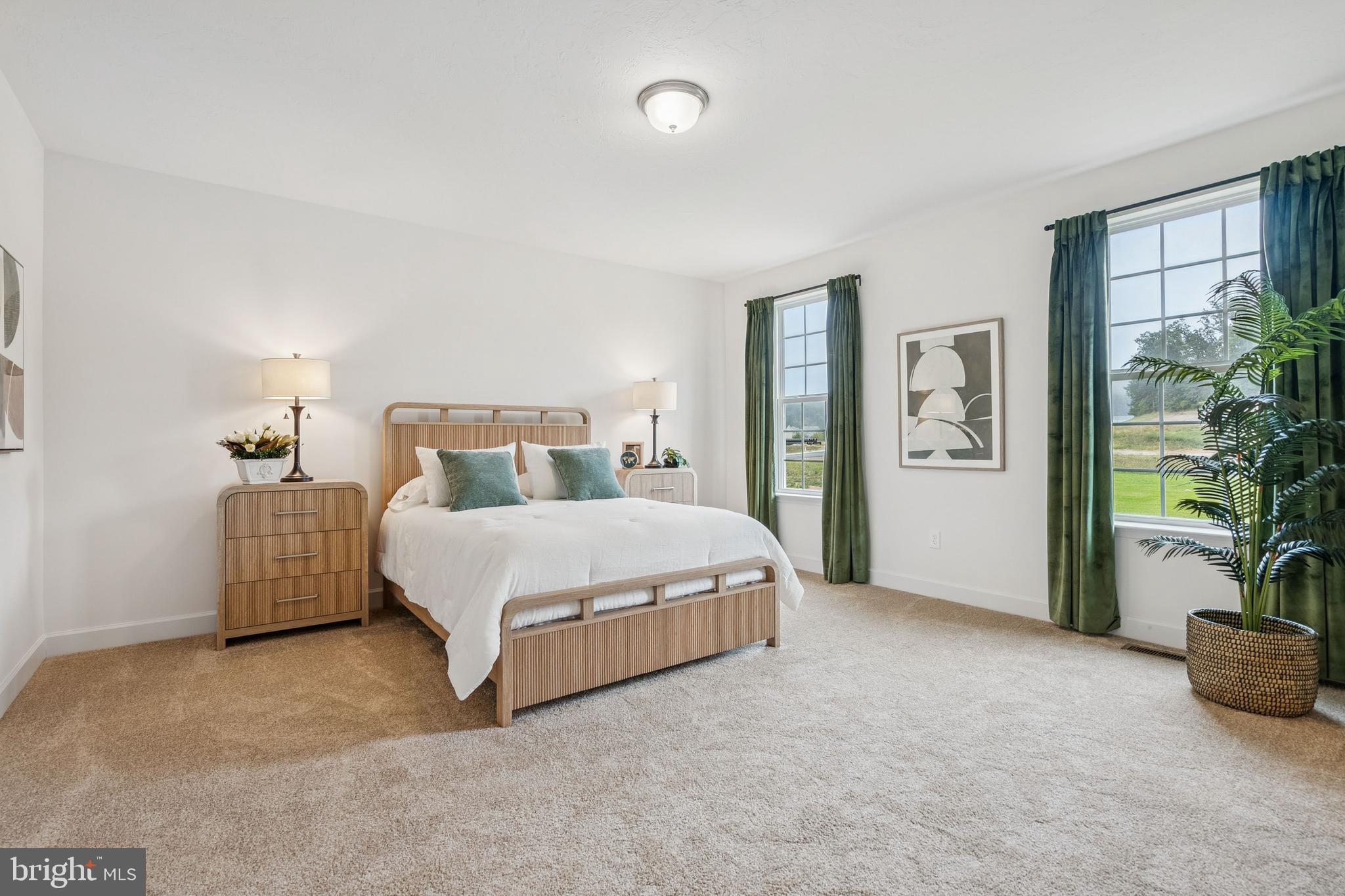 136 Piedmont Way, Unit 102 Hanover, PA 17331 - Photo 25 of 40 a spacious bedroom with a bed and a potted plant