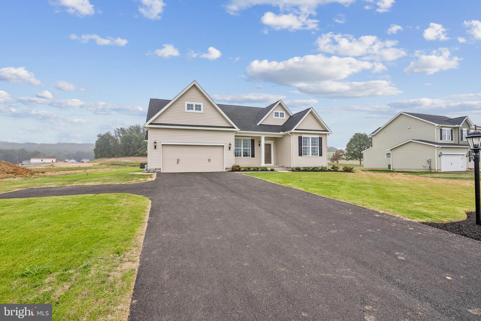 136 Piedmont Way, Unit 102 Hanover, PA 17331 - Photo 3 of 40 a view of a house with a big yard and large trees