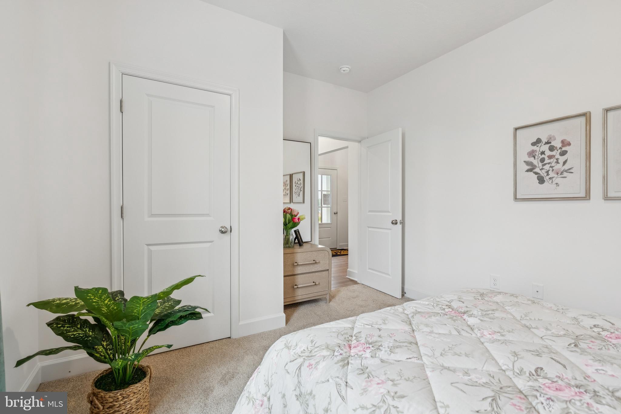 136 Piedmont Way, Unit 102 Hanover, PA 17331 - Photo 36 of 40 a bedroom with a bed and a potted plant