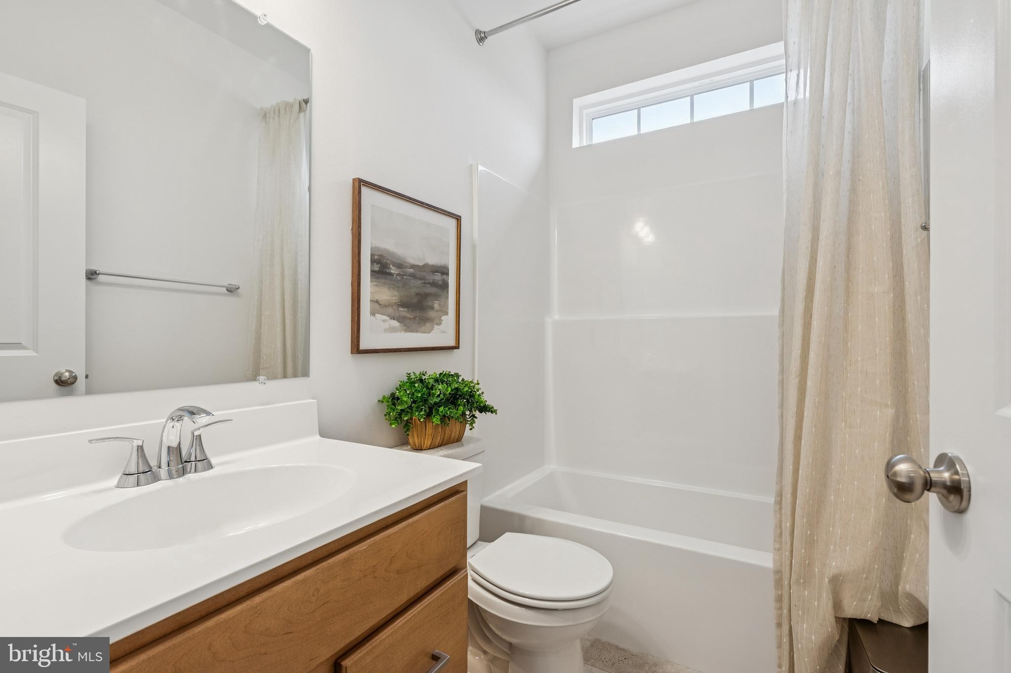 136 Piedmont Way, Unit 102 Hanover, PA 17331 - Photo 37 of 40 a bathroom with a sink toilet and shower