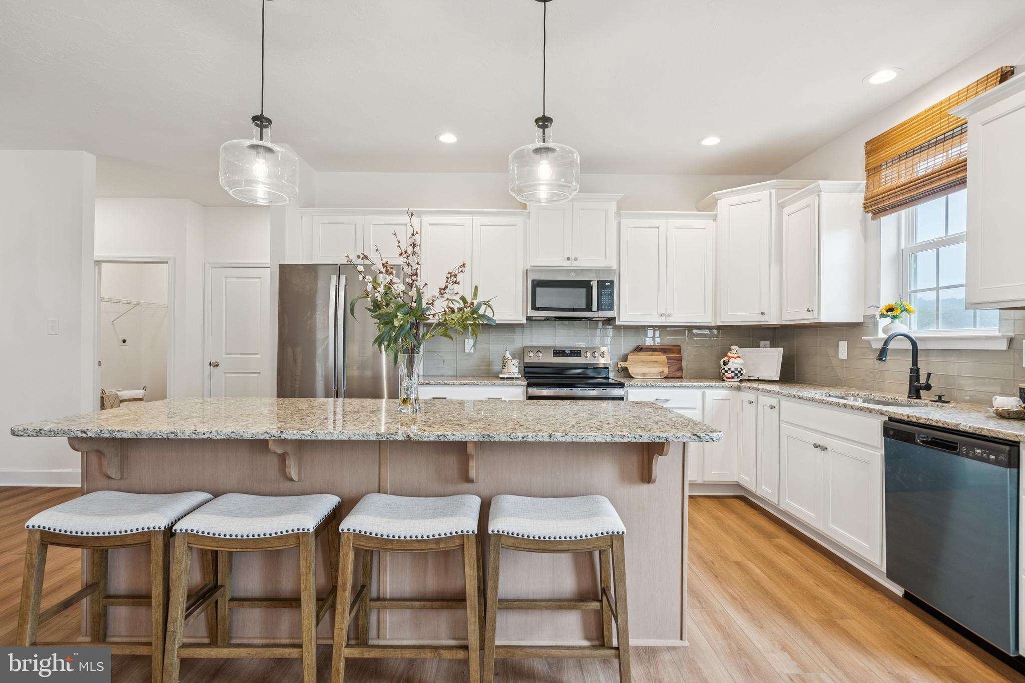 136 Piedmont Way, Unit 102 Hanover, PA 17331 - Photo 8 of 40 a kitchen with stainless steel appliances kitchen island granite countertop a sink and cabinets