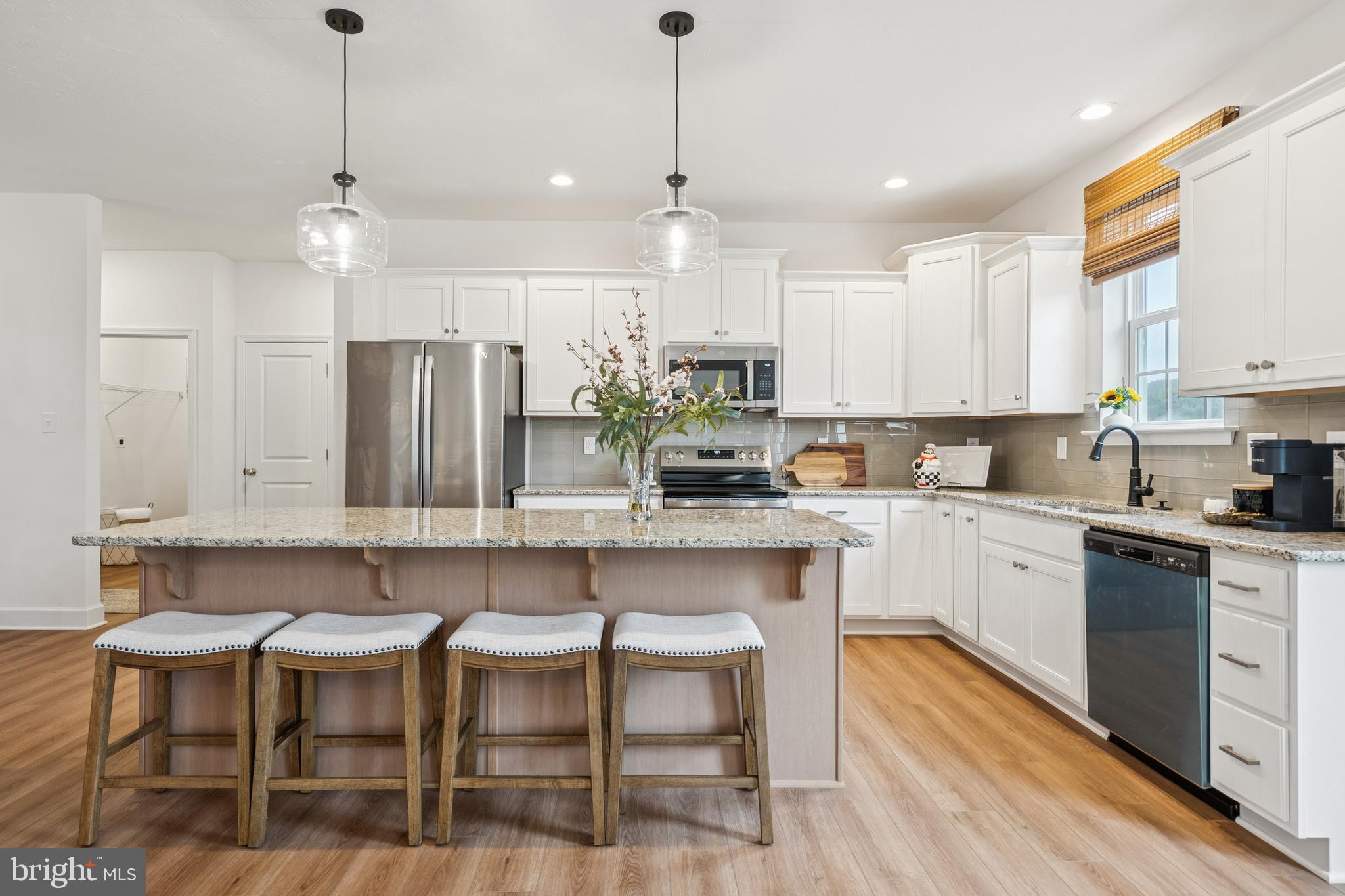 136 Piedmont Way, Unit 102 Hanover, PA 17331 - Photo 9 of 40 a kitchen with a table chairs stove and cabinets