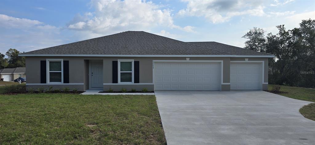 17159 Southwest 42nd Terrace Ocala, FL 34473 - Photo 1 of 17 a front view of a house with a garden