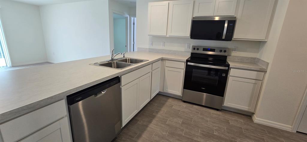 17159 Southwest 42nd Terrace Ocala, FL 34473 - Photo 5 of 17 a kitchen with a sink and a stove top oven