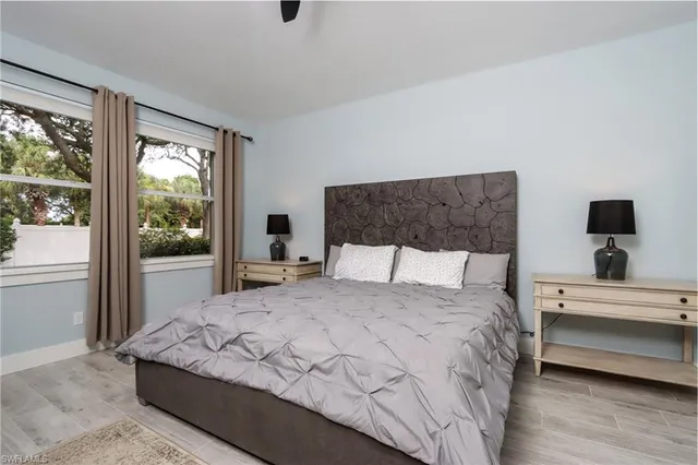 a large bed sitting in a bedroom next to a window