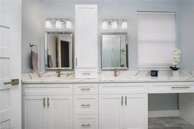 a bathroom with double sink and a mirror