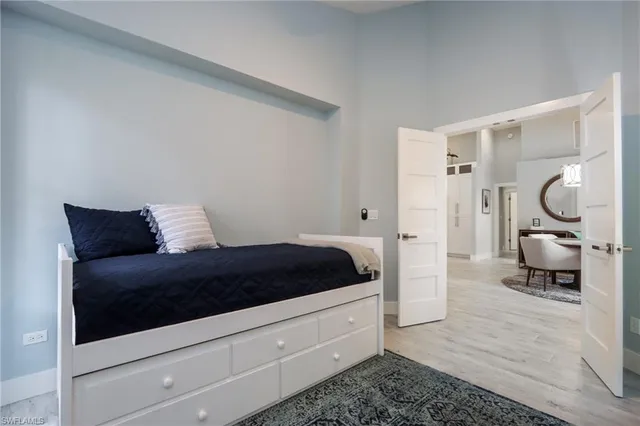 a bedroom with a bed and glass door