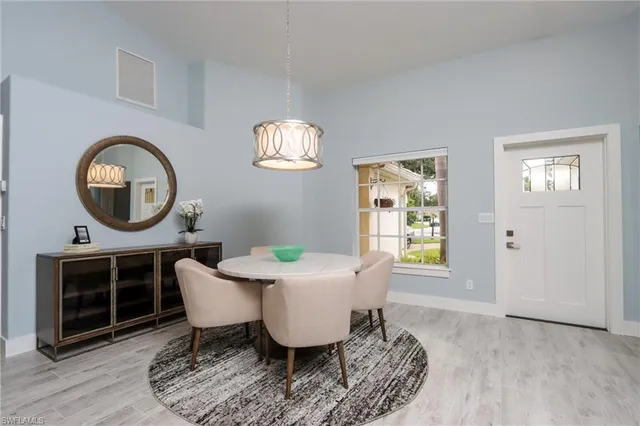 a living room with furniture a window and a mirror