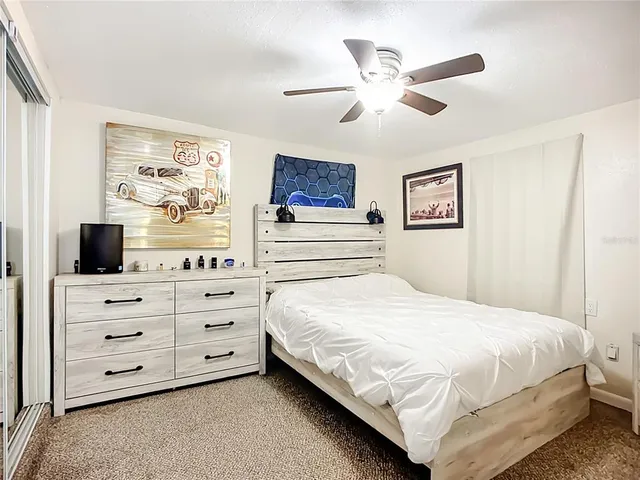 a bedroom with a bed a window and a dresser