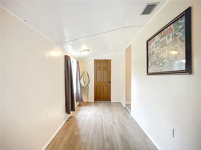 a view of hallway with wooden floor