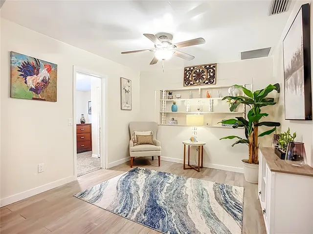 a bedroom with a bed and a potted plant