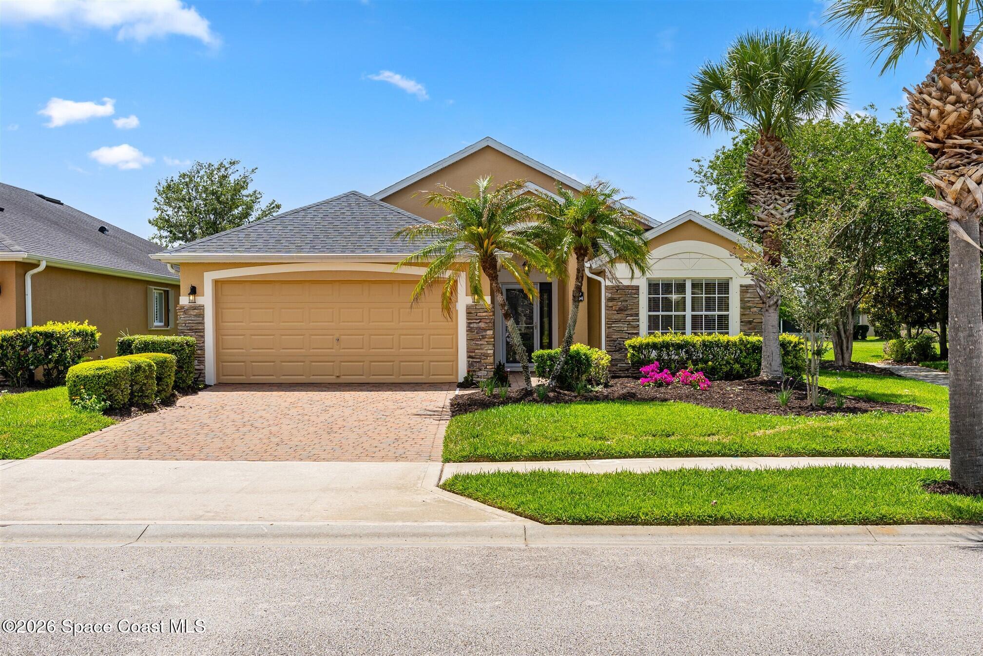 6904 Renshaw Drive Melbourne, FL 32940 - Photo 1 of 46 a front view of a house with a yard and trees