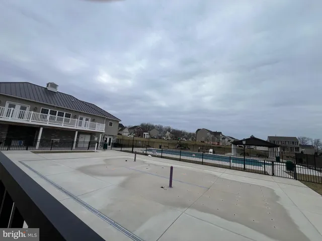 a view of a swimming pool with furniture