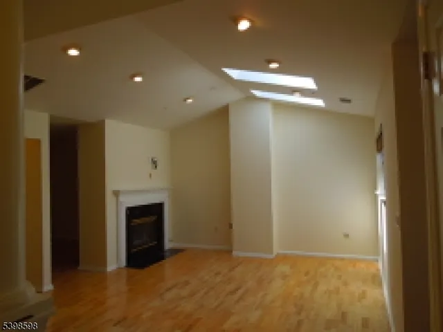 a view of an empty room with a fireplace
