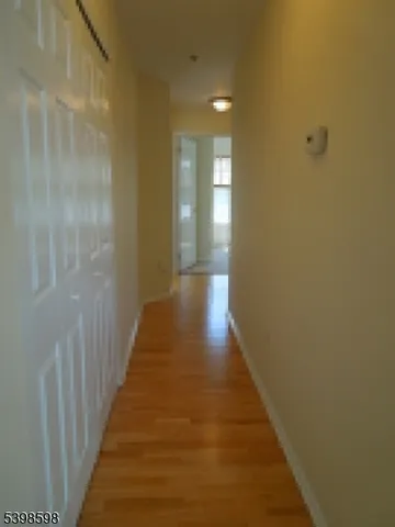 a view of a hallway with wooden floor