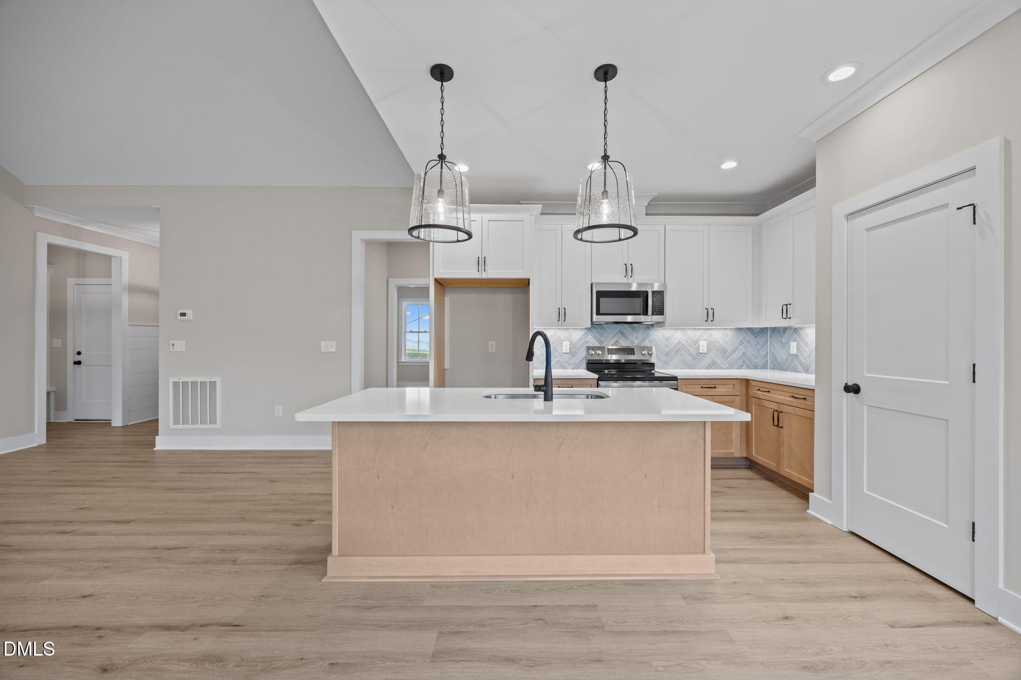 1221 Antioch Church Road Timberlake, NC 27583 - Photo 15 of 45 a large kitchen with stainless steel appliances granite countertop a sink a stove and a wooden floor