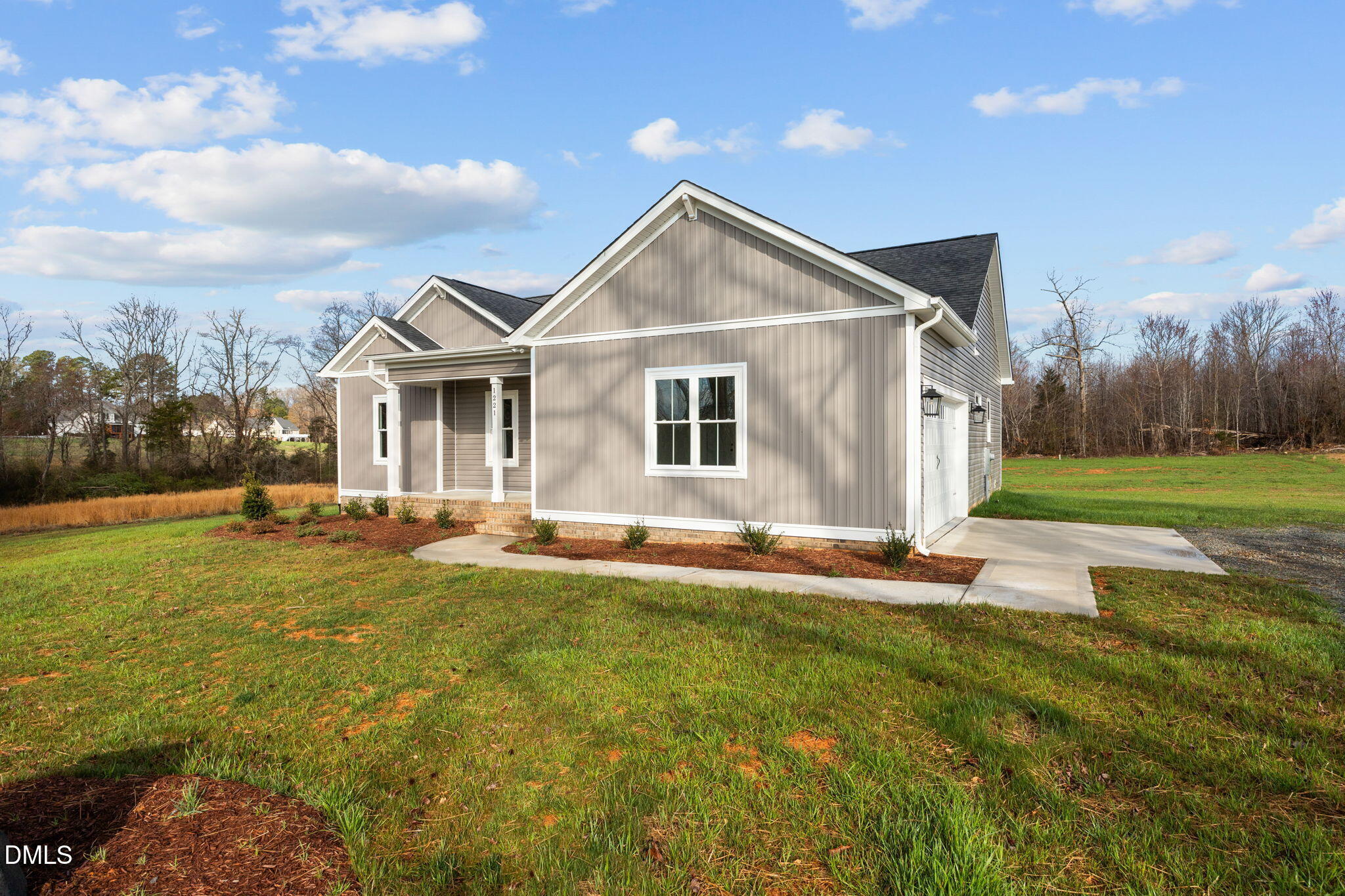 1221 Antioch Church Road Timberlake, NC 27583 - Photo 2 of 45 a view of a house with a yard and garage