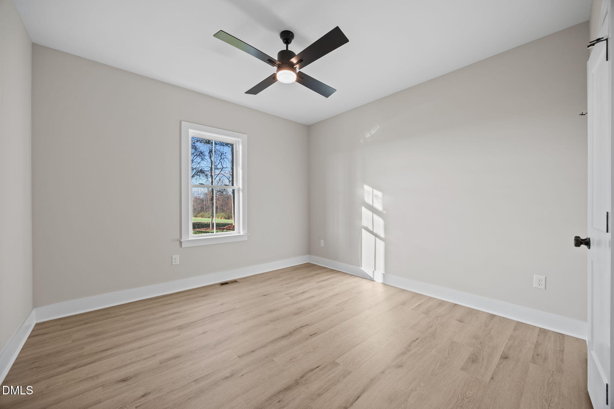 1221 Antioch Church Road Timberlake, NC 27583 - Photo 28 of 45 an empty room with wooden floor and windows
