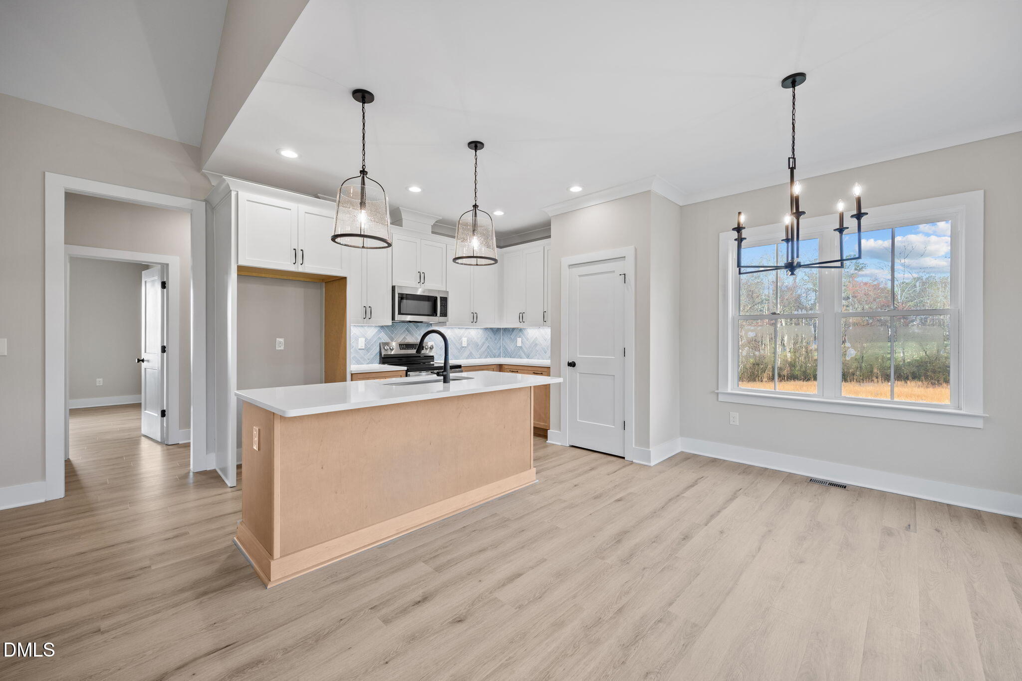1221 Antioch Church Road Timberlake, NC 27583 - Photo 10 of 45 a large kitchen with chandelier and wooden floor