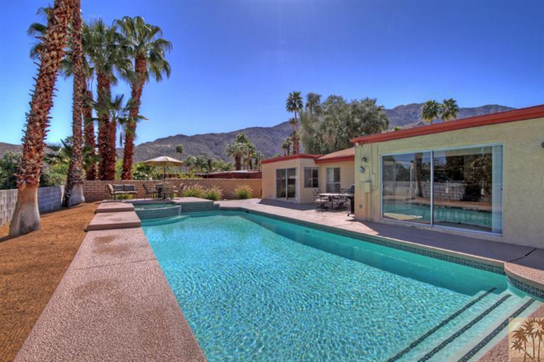 71520 Gardess Road Rancho Mirage, CA 92270 - Photo 1 of 25 swimming pool view with a seating space and a garden view
