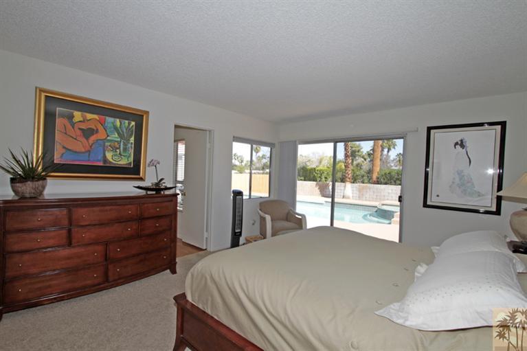 71520 Gardess Road Rancho Mirage, CA 92270 - Photo 17 of 25 a bed room with a bed and a painting on the wall