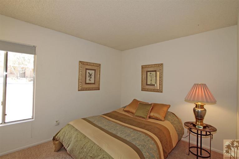 71520 Gardess Road Rancho Mirage, CA 92270 - Photo 19 of 25 a bedroom with a bed and a lamp