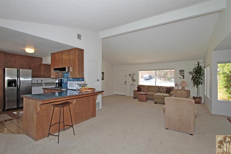 71520 Gardess Road Rancho Mirage, CA 92270 - Photo 7 of 25 a kitchen with stainless steel appliances kitchen island granite countertop a sink and cabinets