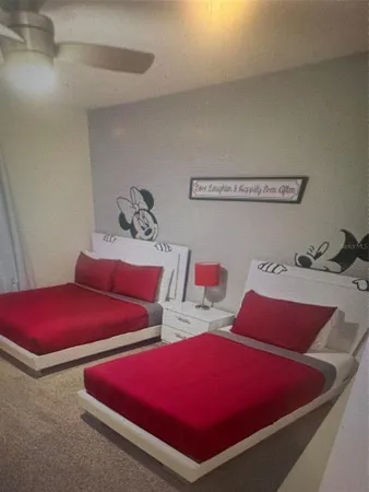 a bedroom with two beds and a dresser