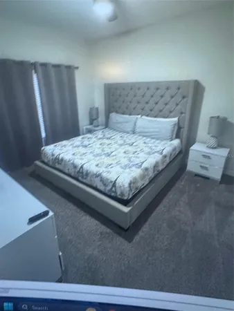 a bedroom with a bed and a night stand