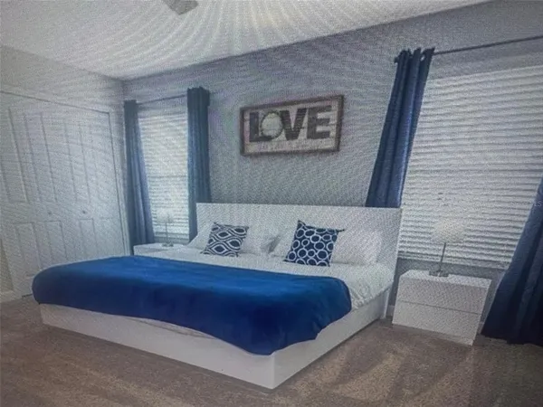 a bedroom with a large bed and a couch