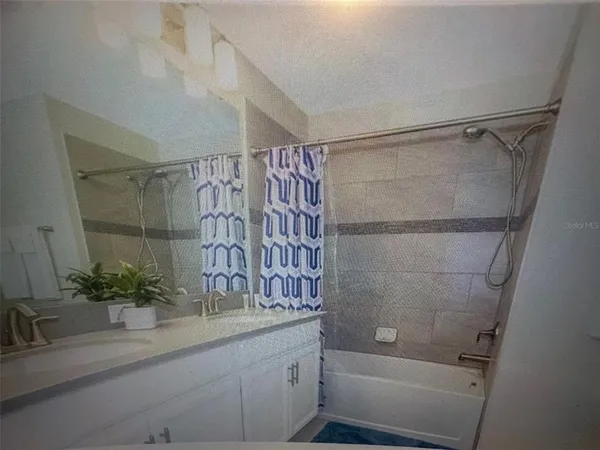 a bathroom with a shower and a sink