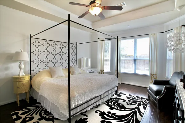 a bedroom with a bed and a chandelier