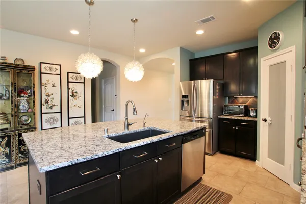 a kitchen with a table chairs sink and cabinets