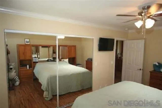 a bedroom with a bed and a mirror