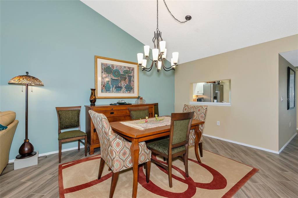 1389 Perico Point Circle, Unit 140 Bradenton, FL 34209 - Photo 21 of 58 a view of a dining room with furniture and wooden floor