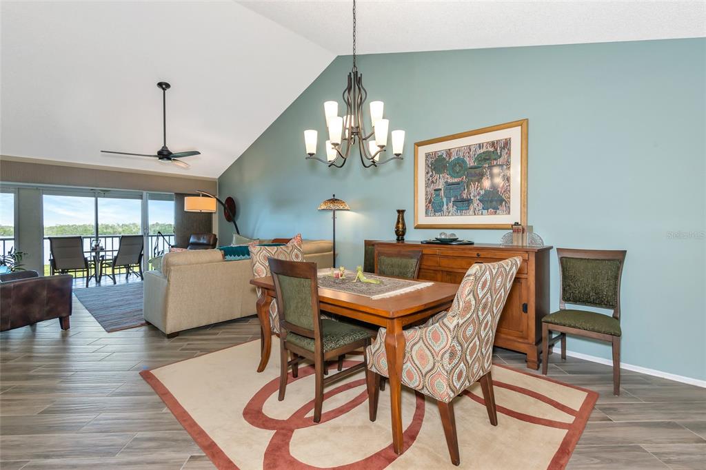 1389 Perico Point Circle, Unit 140 Bradenton, FL 34209 - Photo 22 of 58 a view of a dining room with furniture wooden floor and chandelier