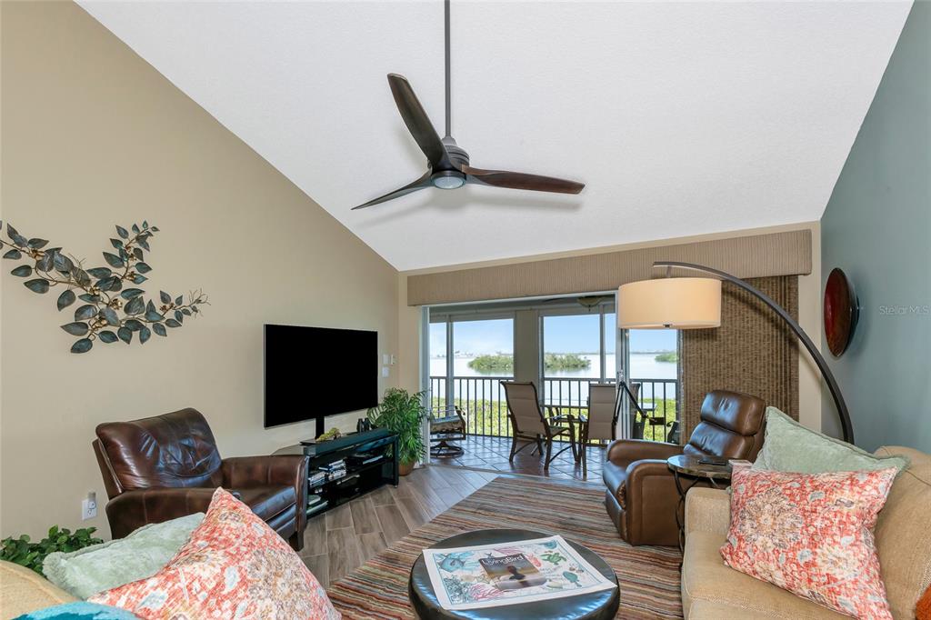 1389 Perico Point Circle, Unit 140 Bradenton, FL 34209 - Photo 23 of 58 a living room with furniture ceiling fan and a flat screen tv