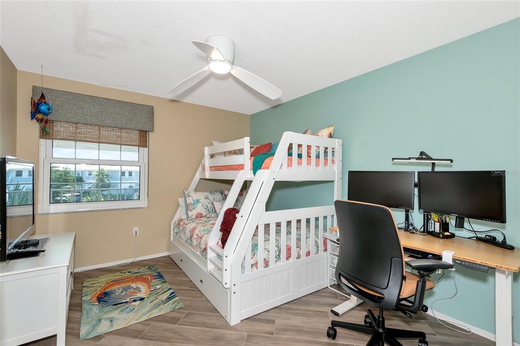 1389 Perico Point Circle, Unit 140 Bradenton, FL 34209 - Photo 37 of 58 a bedroom with furniture and a wooden floor