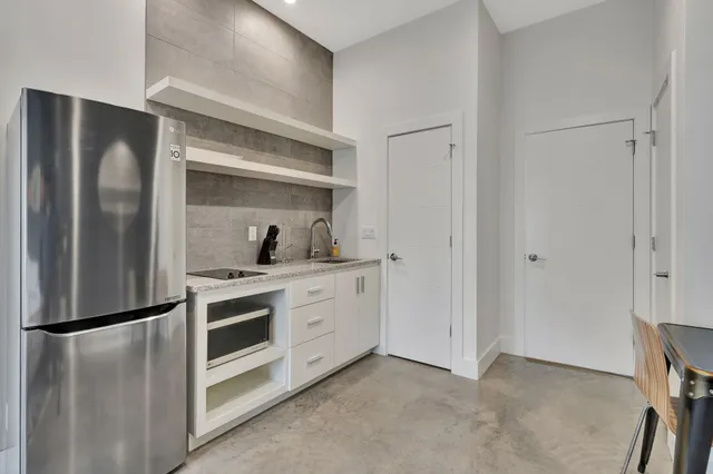 a large bathroom with a granite countertop tub sink and mirror