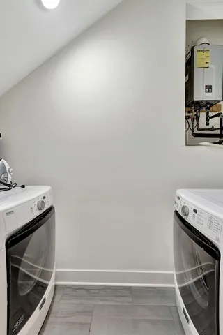 a kitchen with stainless steel appliances granite countertop a table chairs sink and stove