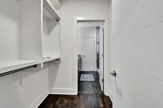 a bathroom with a granite countertop sink toilet and a mirror