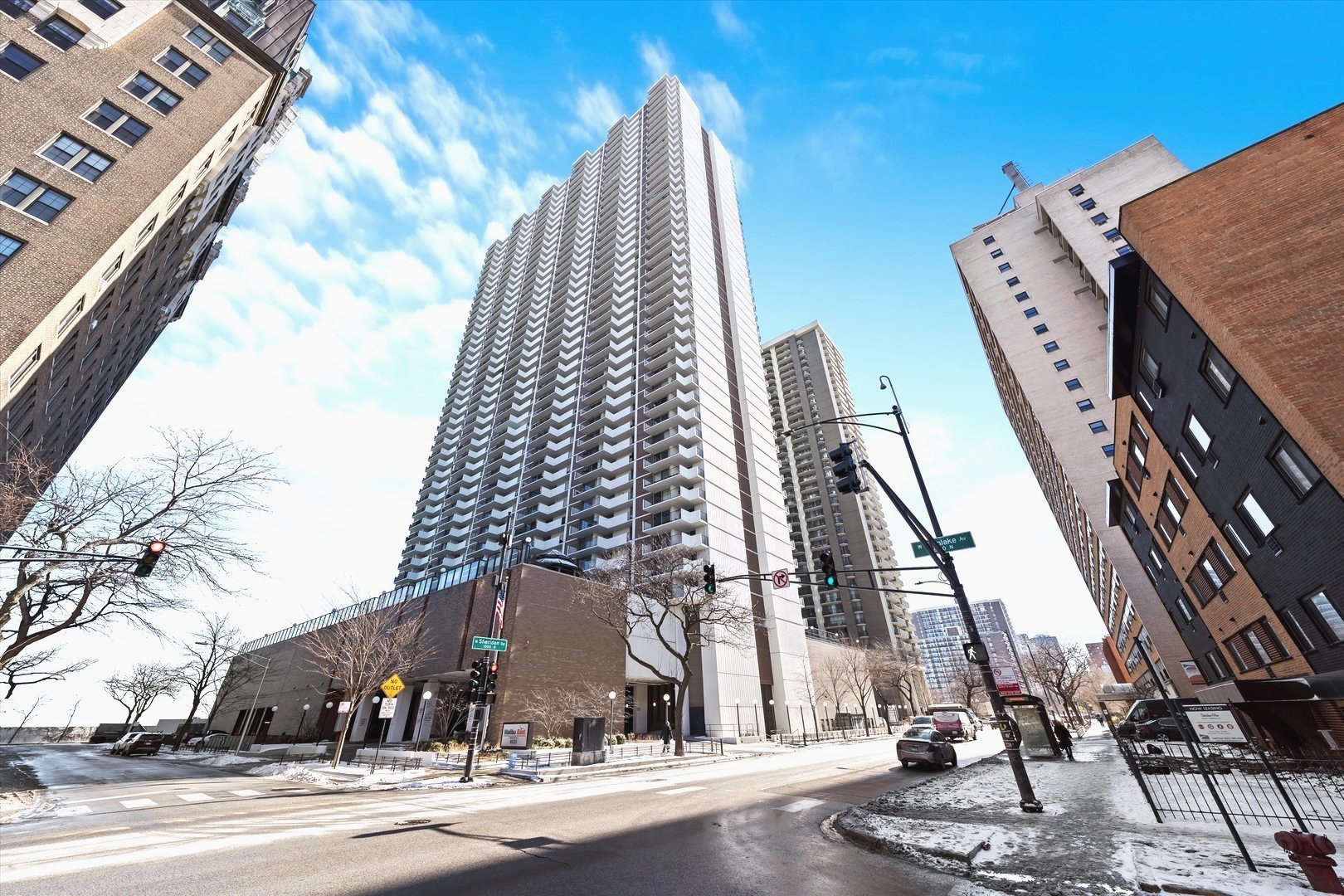 6033 North Sheridan Road, Unit 9E Chicago, IL 60660 - Photo 2 of 23 a view of a tall building next to a road