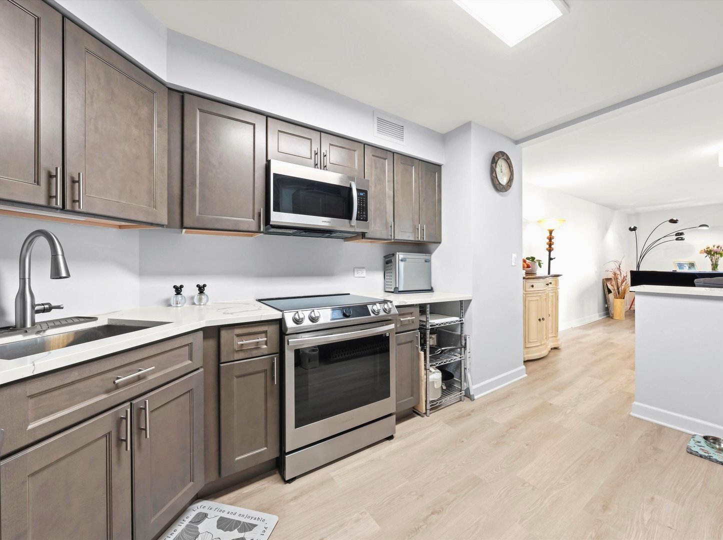 6033 North Sheridan Road, Unit 9E Chicago, IL 60660 - Photo 6 of 23 a kitchen with cabinets stainless steel appliances and sink