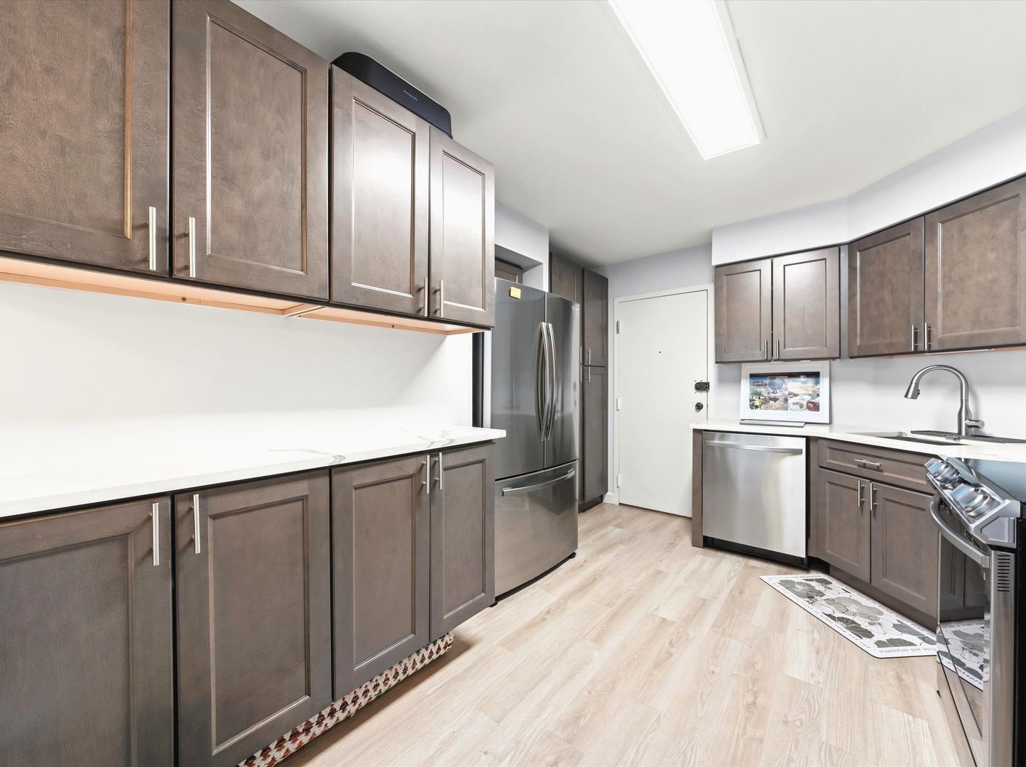 6033 North Sheridan Road, Unit 9E Chicago, IL 60660 - Photo 8 of 23 a kitchen with a refrigerator sink and cabinets