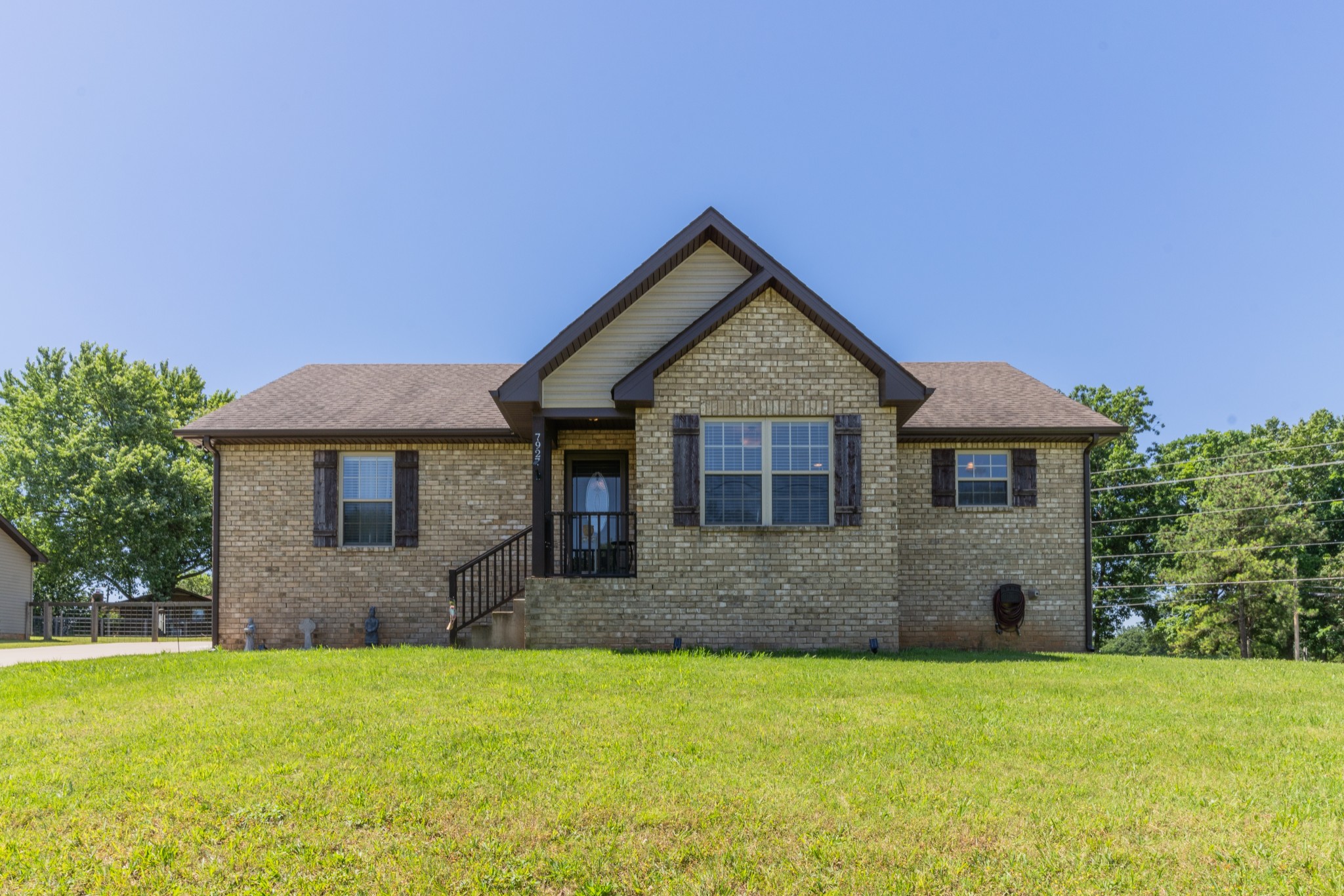 7927 Cedar Grove Road Cross Plains, TN 37049 - Photo 1 of 26 a front view of a house with garden