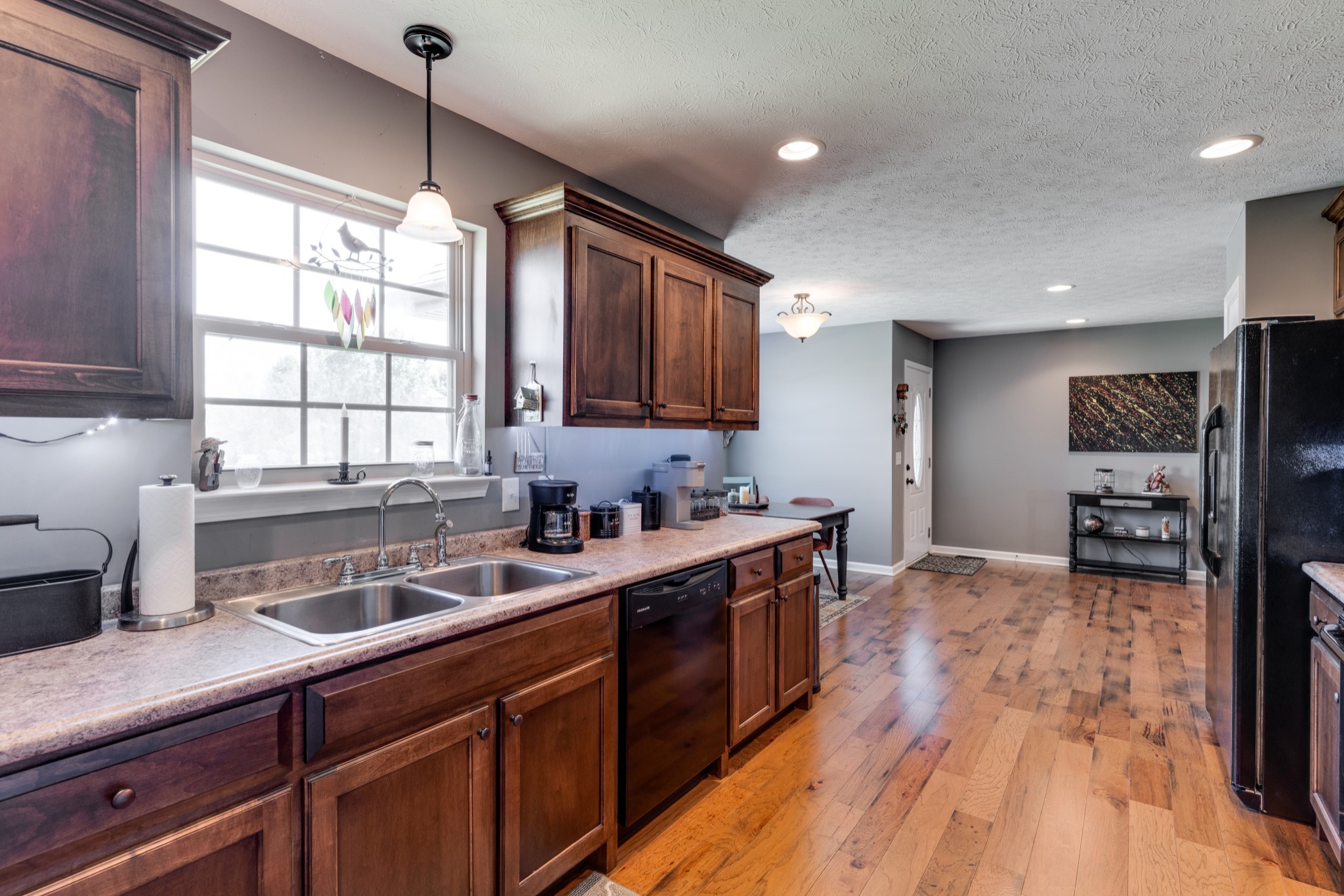 7927 Cedar Grove Road Cross Plains, TN 37049 - Photo 9 of 26 a kitchen with stainless steel appliances granite countertop a sink a stove and a wooden floors