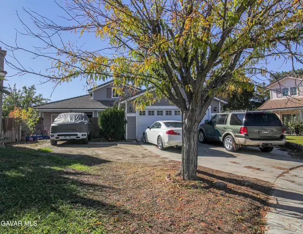 a view of a car park in front of a house