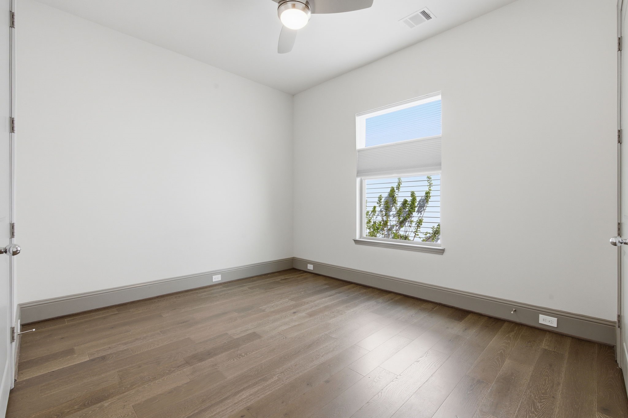 1906 West 25th Street Houston, TX 77008 - Photo 24 of 47 Second floor: Bedroom 3 of 4 complete with ceiling fan, custom window treatments.