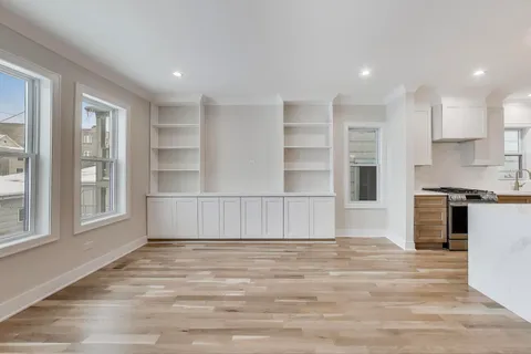 a view of kitchen with wooden floor and windows